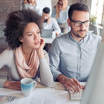 young woman and man working at a computer