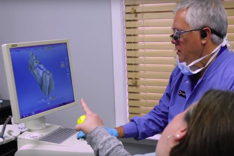 Dr. Wright and a dental patient looking at a CEREC monitor