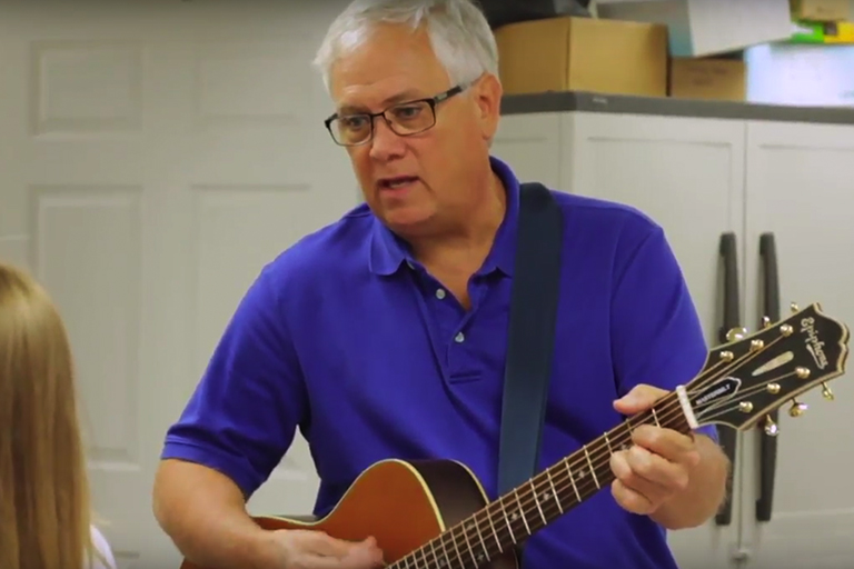 Screenshot of Dr. Wright playing guitar at Harrisonburg Family & Cosmetic Dentistry