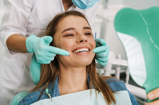 smiling girl having a checkup at the dentist's office