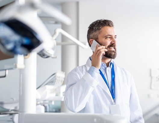 doctor smiling and talking on the phone