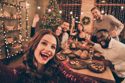 smiling people gathered around a festive dinner